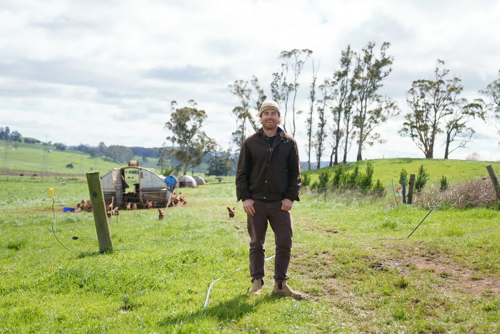 Hayden Quinn with two people and cattle in a field