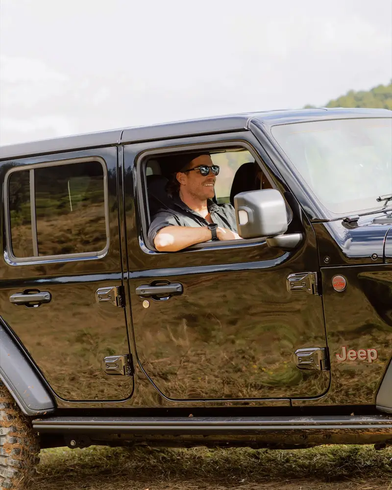 Hayden Quinn driving a Jeep, with Jax Quinn in the passenger seat