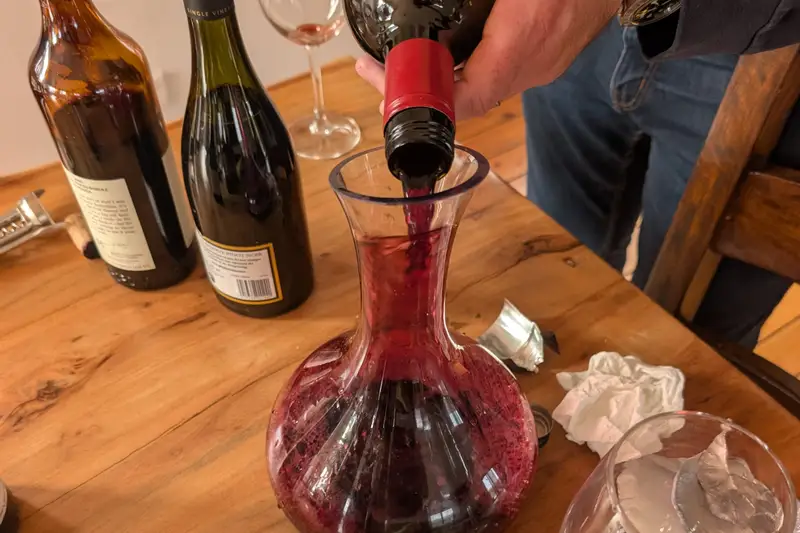 Red wine being poured into a decanter