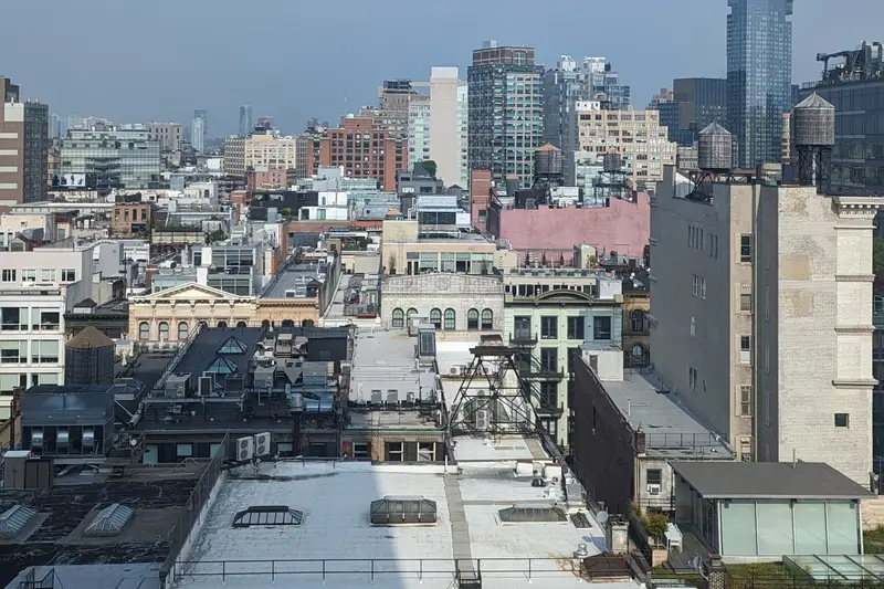 View over New York rooftops and water towers to the skyline