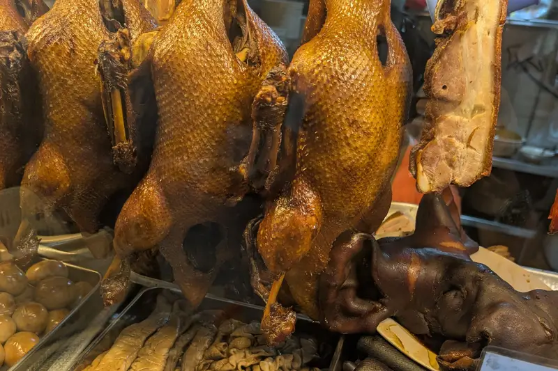 Roast ducks hanging in a hawker stall window