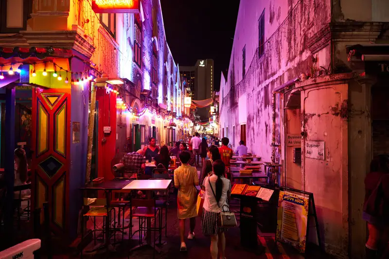 Colourful lit-up lane of bars and shophouses at night