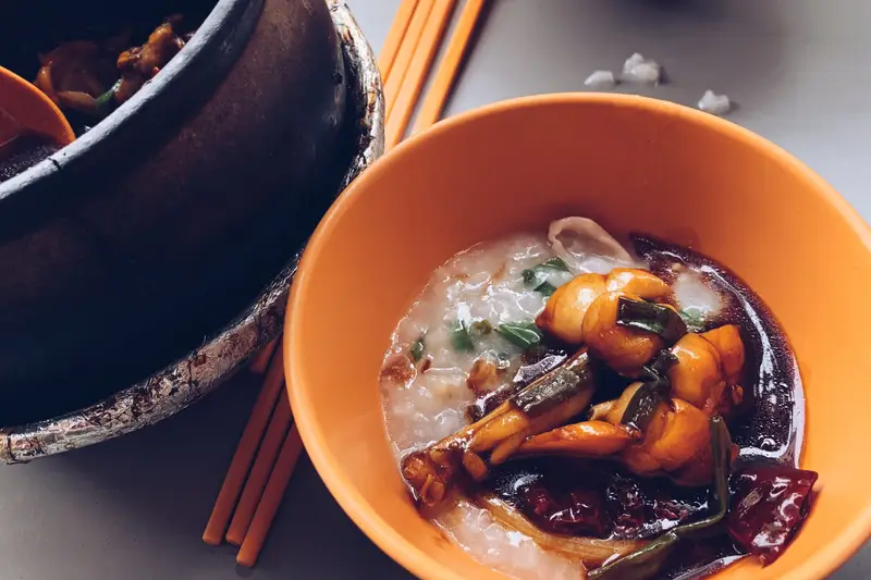 Bowls of hawker food with chopsticks on a metal table