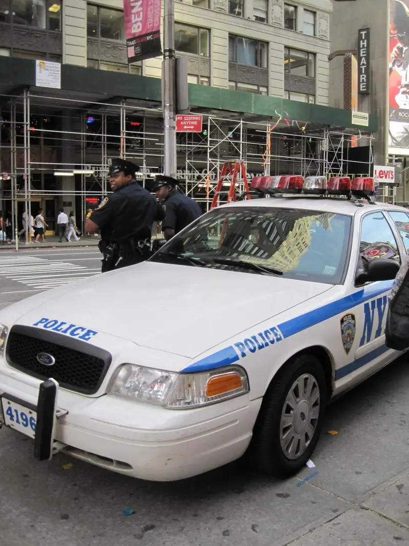 An NYPD patrol car parked on a Midtown street