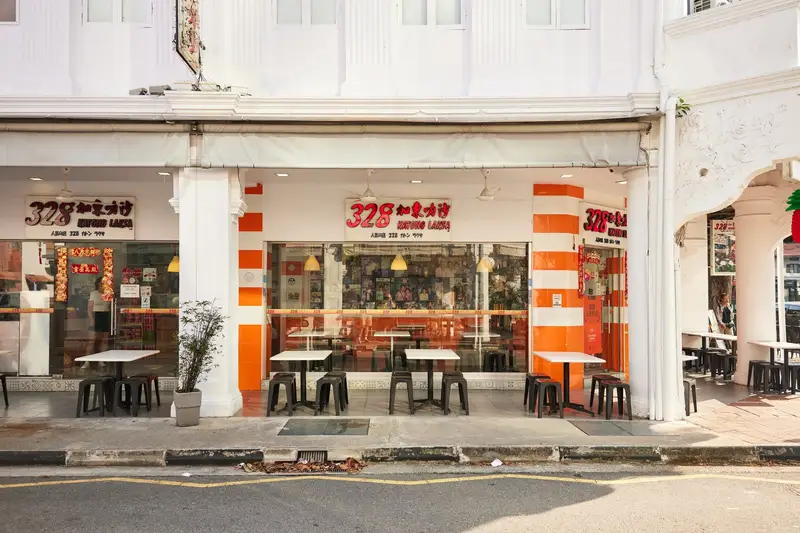 The 328 Katong Laksa shopfront, a white shophouse with orange-striped columns